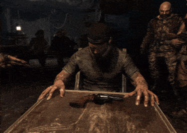 a man is sitting at a table with a gun in front of him