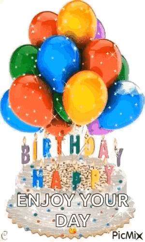 a birthday cake with balloons and candles on top of it .