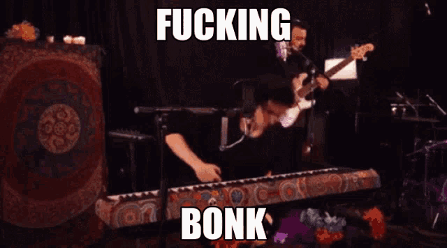 a man is playing a guitar and singing into a microphone with the words " fucking bonk " above him