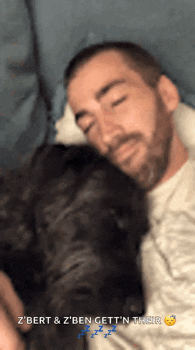 a man with a beard is sleeping on a couch with a cat and the words z bert & z ben get n their