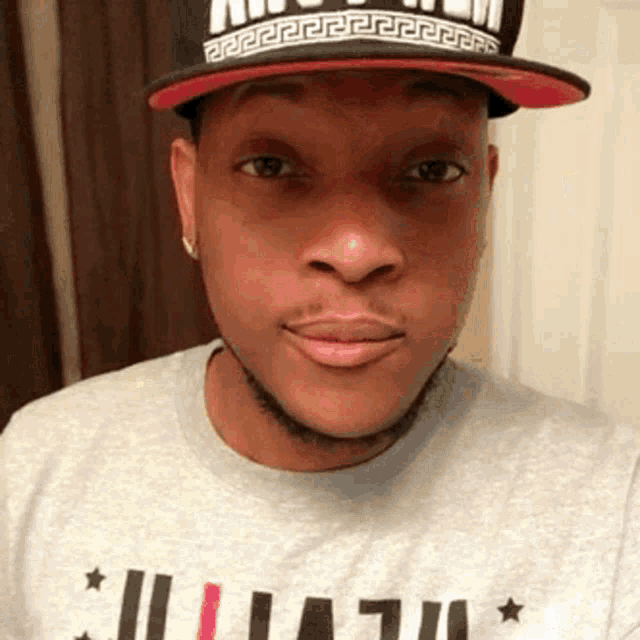 a man wearing a hat and a t-shirt that says ' ii ' on it