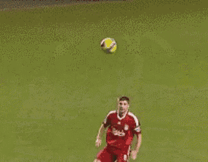 a soccer player wearing a carlsberg jersey is jumping in the air