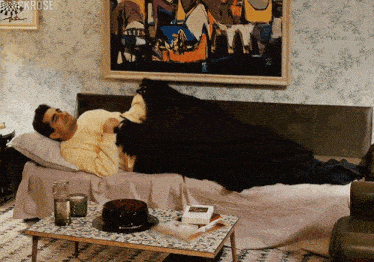 a man laying on a bed under a painting that says krose on the bottom
