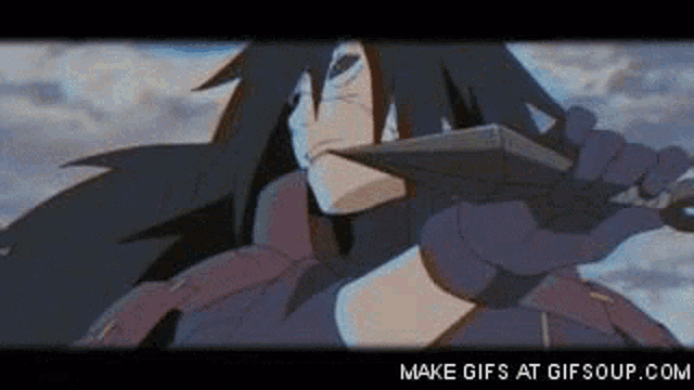 a man with long hair is holding a sword in his hand and looking at the camera .