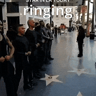 a group of people standing in a hallway with the word ringing on it