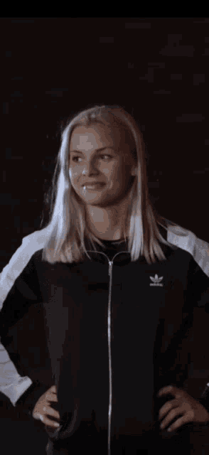 a woman wearing a jacket that says volt vol on it