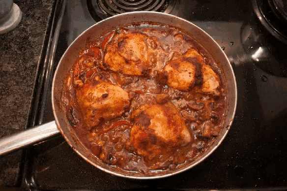 a pan of chicken stew on a stove top