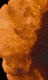 a close up of a statue with smoke coming out of it against a black background