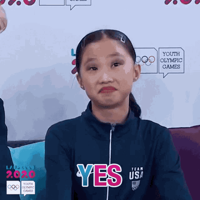 a young girl wearing a jacket that says team usa on it
