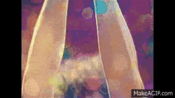 a woman 's legs are shown in a pixelated video with a purple background .