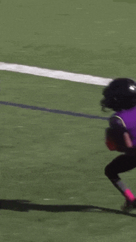 a football player wearing a helmet with the letter t on it