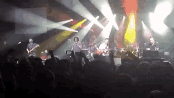 a group of people are playing instruments on a stage