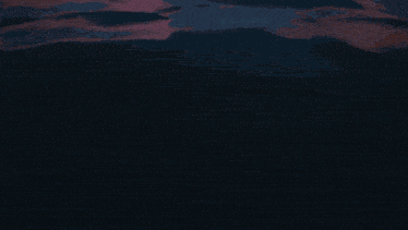 a silhouette of a person swimming in a body of water
