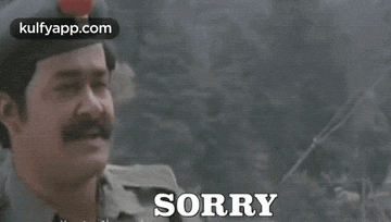a man with a mustache is wearing a hat and says `` sorry '' .