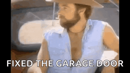 a man with a beard and a cowboy hat is smoking a cigarette in a car .