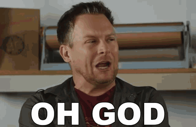 a man in a leather jacket is making a funny face with the words oh god written on his face .