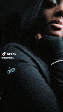 a woman is sitting in a car with a tiktok watermark on her face