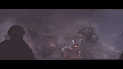 a large monster is destroying a city with a soldier holding a gun in the foreground
