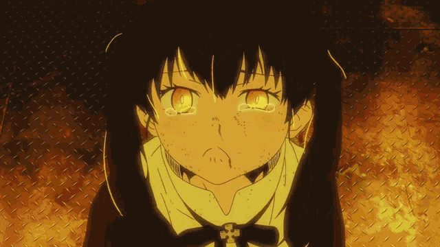a girl with tears coming out of her eyes is standing in front of a fire