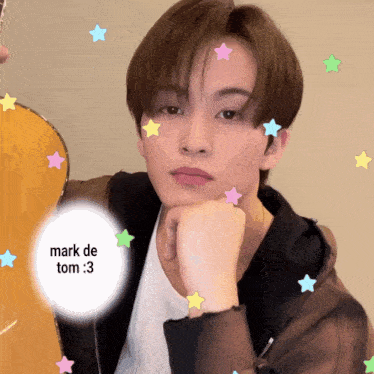 a young man with a guitar and a sticker that says mark de tom 3