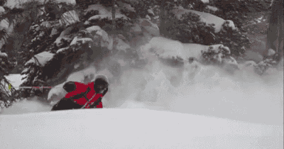 a person is skiing down a snow covered hill .