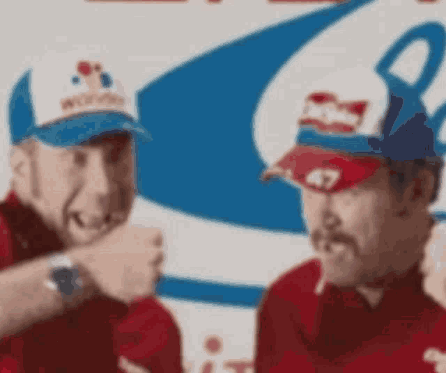 a man wearing a budweiser hat stands next to another man