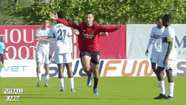 a soccer player wearing a red jersey with the number 21 on it