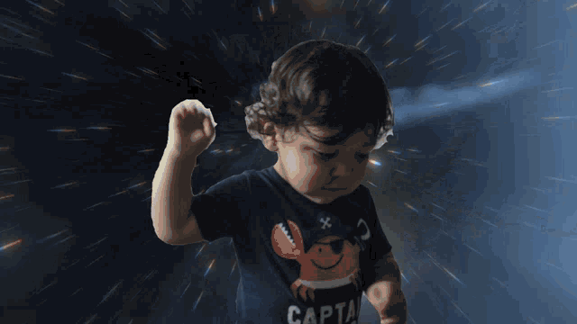 a young boy wearing a shirt that says captain on it