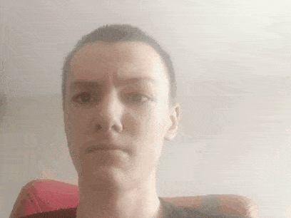 a woman with a very short haircut is making a funny face