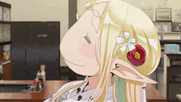 a blonde anime girl with a flower in her hair making a funny face