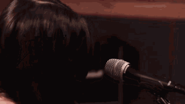 a man and a woman are singing into microphones