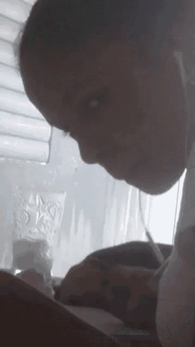 a woman is writing on a piece of paper with a pen