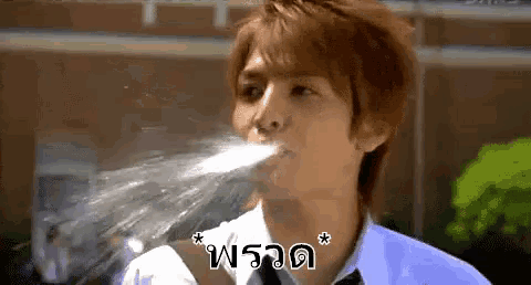 a man in a white shirt and tie is drinking water from a bottle ..