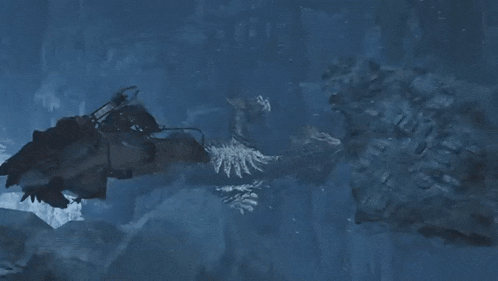a man is swimming in the water with a sword in his hand and a monster is coming out of the water .