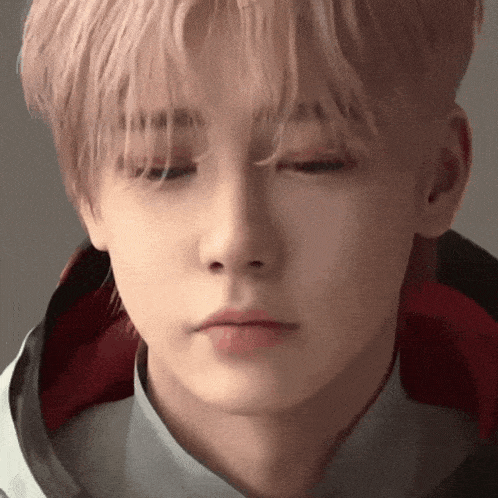 a close up of a young man with his eyes closed