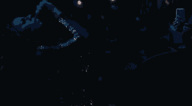 a blurry picture of a group of people standing in the dark