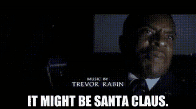 a man in a dark room with the words " it might be santa claus "