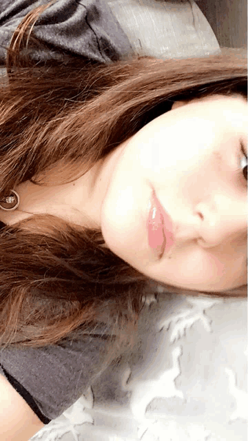 a close up of a woman 's face with a red lip