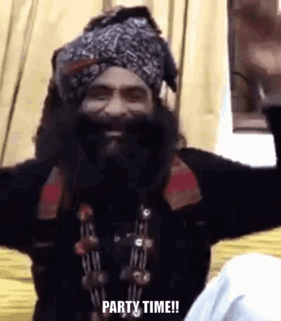 a man with a beard is wearing a turban and a necklace and says party time .