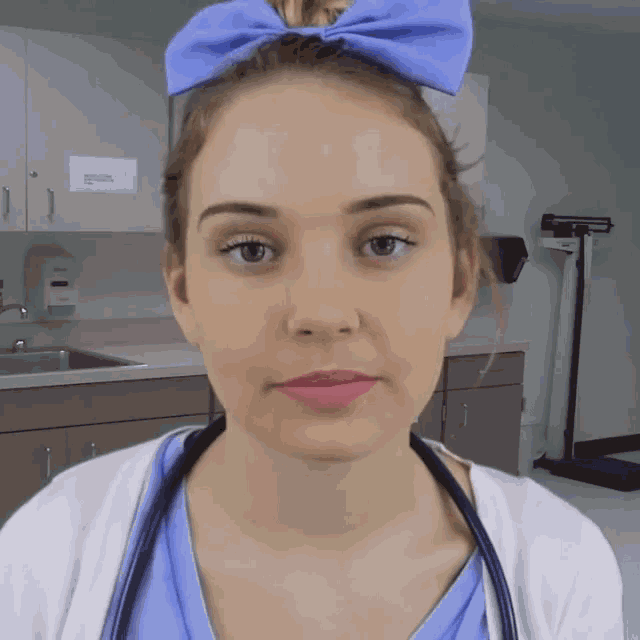 a woman with a blue bow in her hair