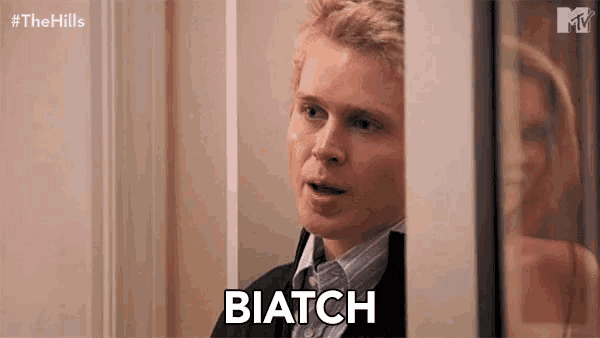 a man in a suit says biatch in front of a woman