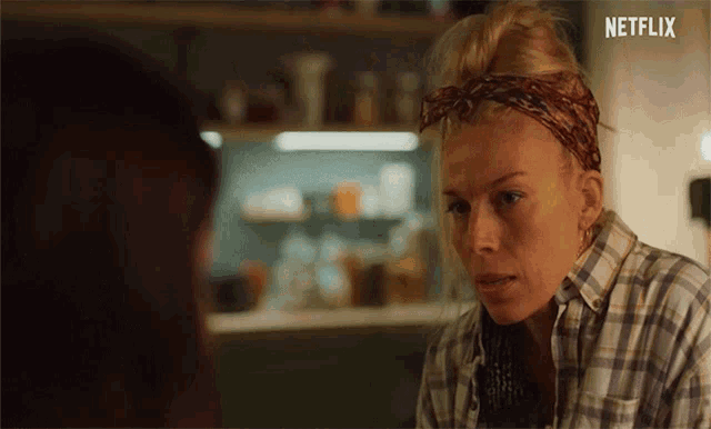 a woman in a plaid shirt talking to another woman with netflix written on the bottom