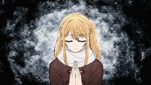 a girl praying with her eyes closed and her hands folded