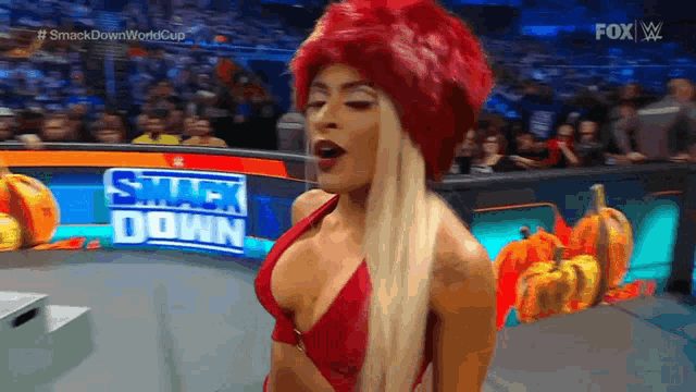 a woman in a red bikini is standing in front of a smack down sign