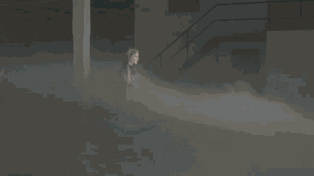 a woman is standing in a dark room surrounded by smoke