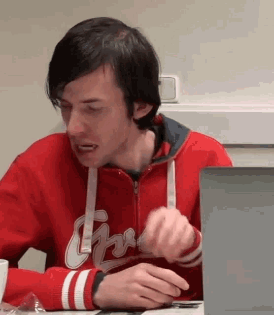 a man wearing a red sweatshirt that says chicago on it