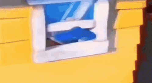 a close up of a toy house with a blue item coming out of it .