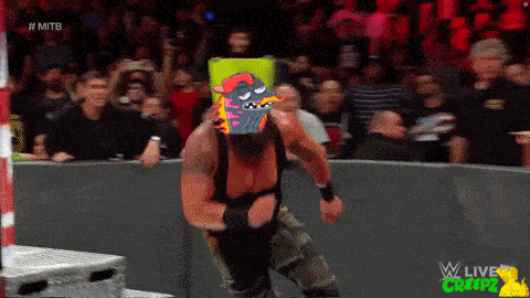 a wrestling match is being shown on a screen that says ' wwe live '