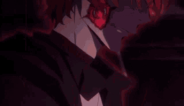 a close up of a person holding a sword in their hand in a dark room .