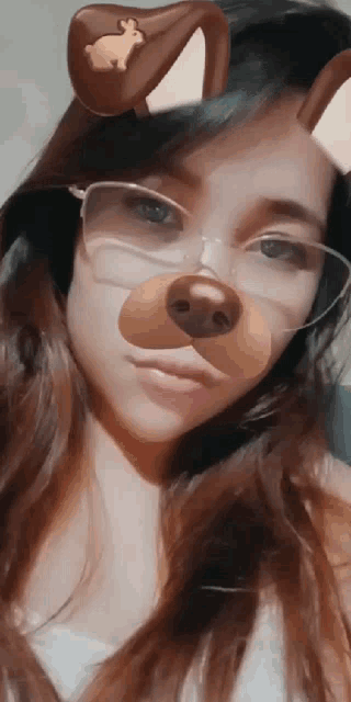 a woman wearing glasses and a bunny mask on her face